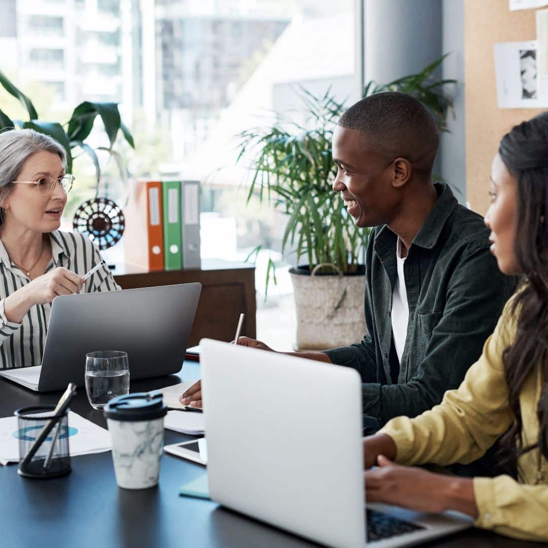 A pair of real estate investors meeting with their financial advisor.