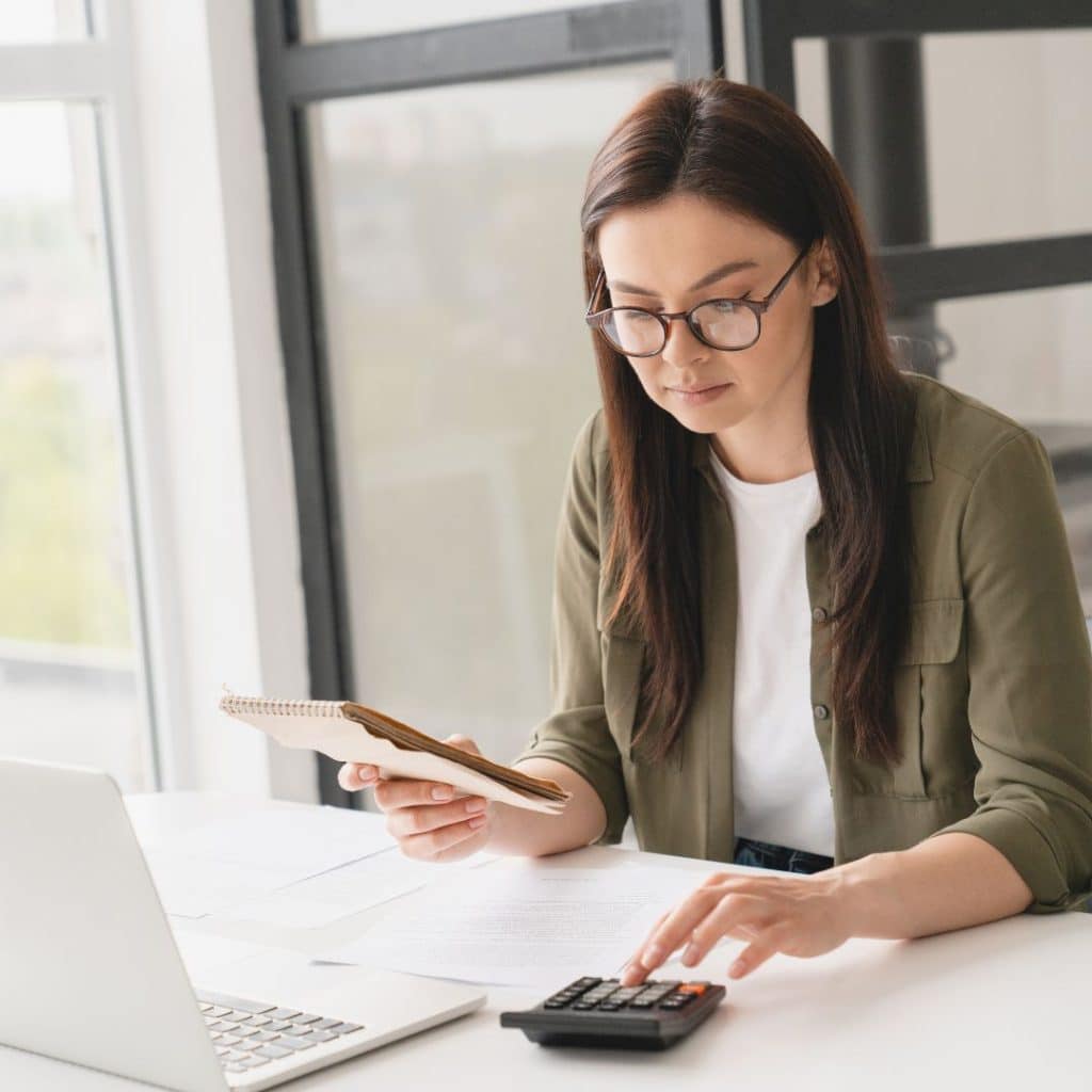 A bookkeeper working on a firm's monthly reports.