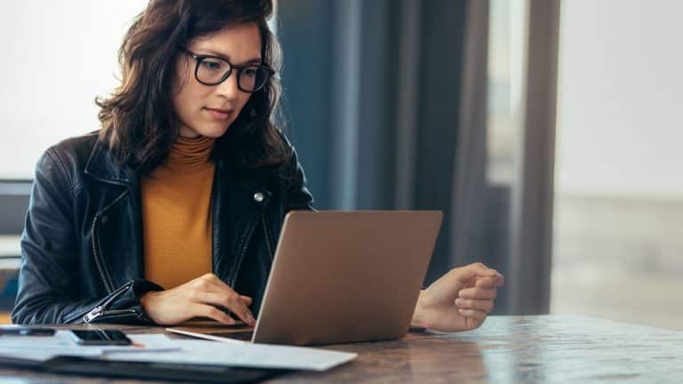 A professional woman working at a laptop.