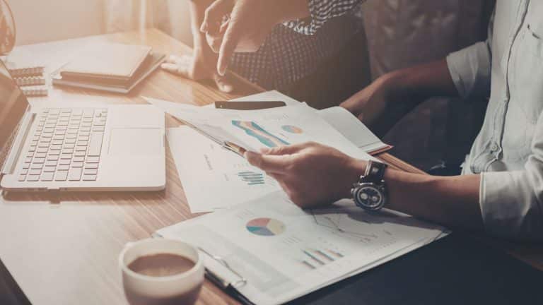 Two people discussing financial documents.