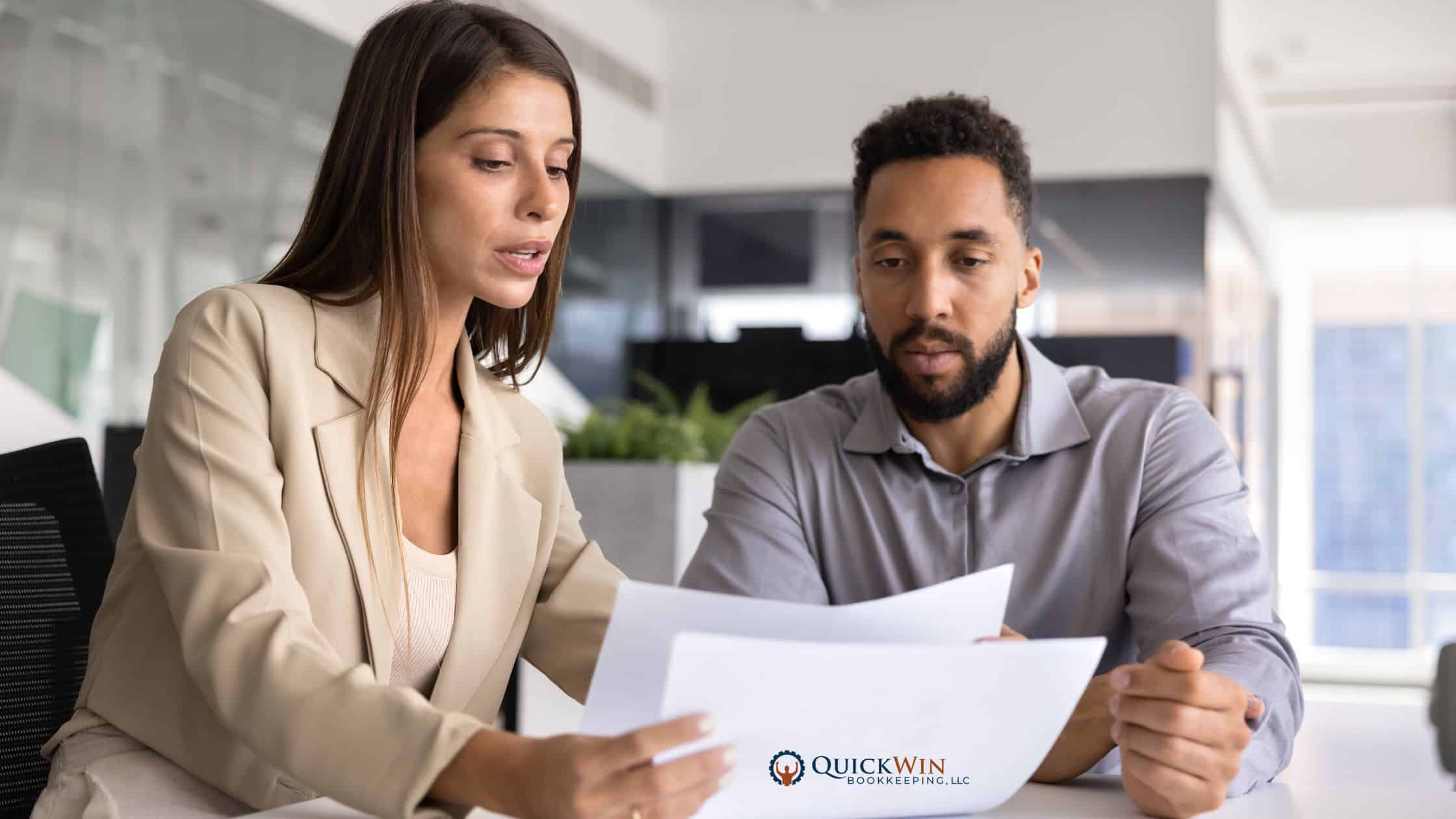 A bookkeeper meeting with her client to go over financial strategy for his firm.