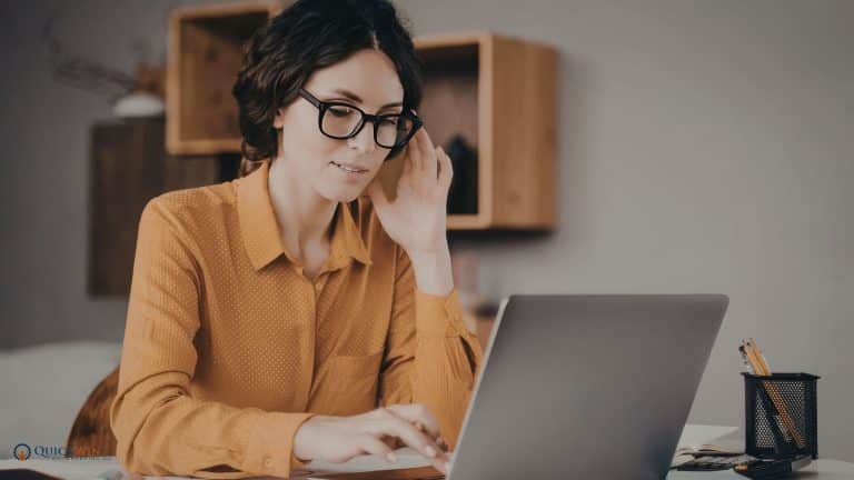 A law firm owner working on her laptop to make year-end decisions for her firm.